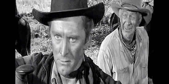 Kitk Douglas as Len Merrick, ratled by comments about his father from Pop Keith (Walter Brennan) in Along the Great Divide (1951)