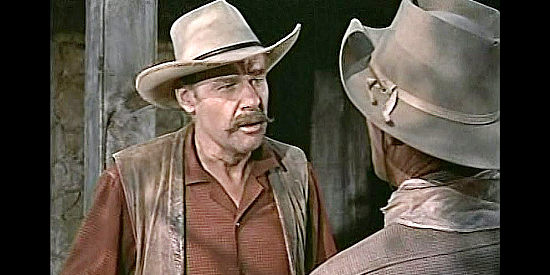 Lane Chandler as Hap Sutton, revealing Tuck Ordway's secret to Larry Madden in Tall Man Riding (1955)