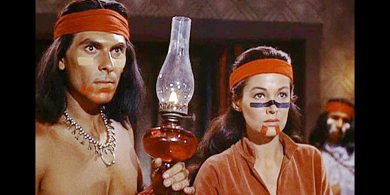 Larry Chance as Ponce and Joan Taylor as Riva, hearing an 'Americano medicine man' explain Mangas's wound in War Drums (1957)