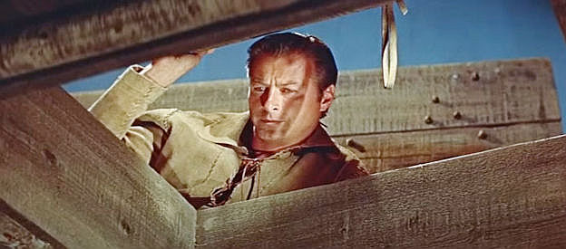 Lex Baker as Deerslayer, discovering the hiding spot for Tom Hutter's gold and scalps in The Deerslayer (1957)