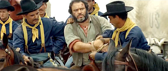 Mario Brega as Big Sam Donaldson, taken into custody for suspected gun-running in Buffalo Bill, Hero of the Far West (1965)