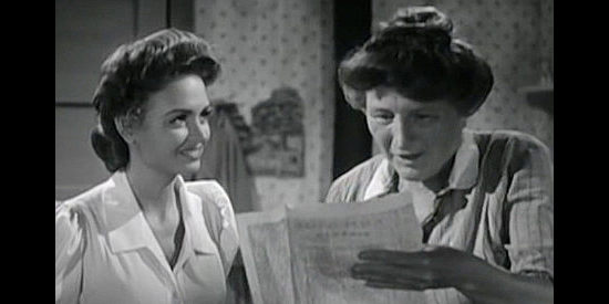 Marjorie Main (right) as Annie Goss shows Mary Lingen a picture of the hat she dreams of owning in Gentle Annie (1944)
