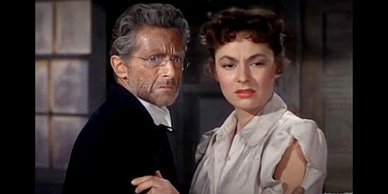 Morgan Farley as the Judge and Ruth Roman as Judith Burns, watching Bob Peters being beaten in Barricade (1950)