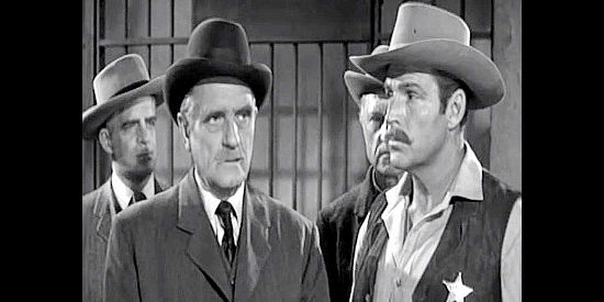 Morris Ankrum as Mayor Coleman, making a point as Wyatt Earp (Buster Crabbe) looks on in Badman's Country (1958)