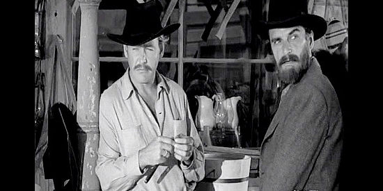 Myron Healy as Cole Younger and Henry Brandon as Jesse James, checking out the streets of Rayville prior to a jailbreak in Hell's Crossroads (1957)