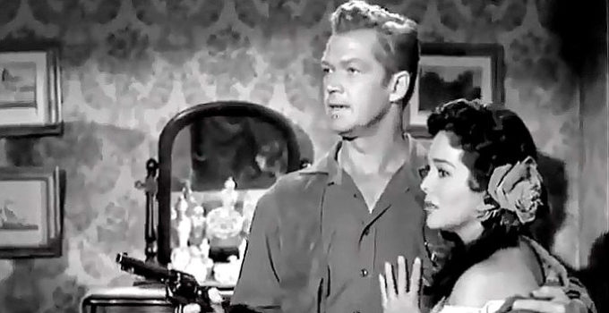 Bill Williams as Deputy Bill Gentry defending girlfriend Conchita (Rita Baron) in The Broken Star (1956)