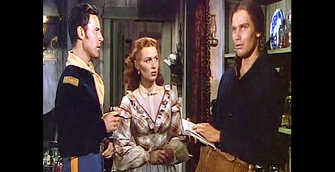 Charlton Heston (right) as Jim Aherne, remembering back to his upbringing with Lt. Hathersall (Peter Hansen) and his sister Talley (Susan Morrow) in The Savage (1952)