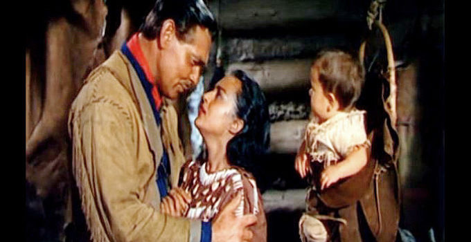 Clark Gable as Flint Mitchell, realizing how much he loves Kamiah (Maria Elena Marques) after the birth of their son in Across the Wide Missouri (1951)