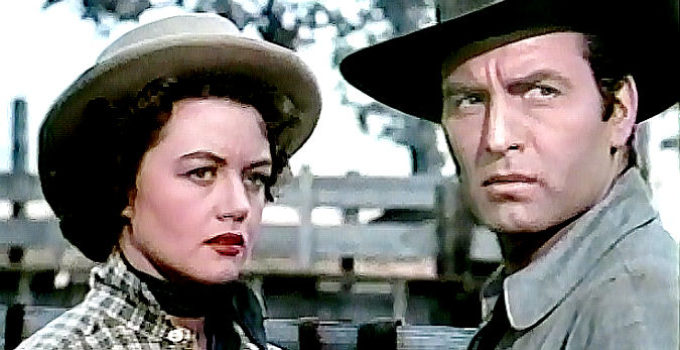 Dorothy Malone as Charlotte Downing and George Montgomery as Cruze, realizing they have a common goal in The Lone Gun (1954)