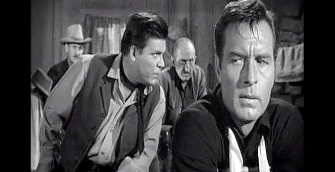George Montgomery as Pat Garrett, listening in on the outlaw's plans while held captive in their lair in Badman's Country (1958)