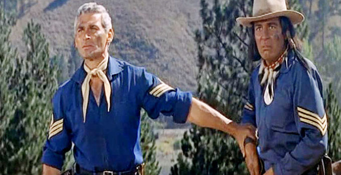 Jeff Chandler as 1st Sgt. Emmett Bell and Sydney Chaplin as Timothy, one of his scouts, watching a war party approach in Pillars of the Sky (1956)