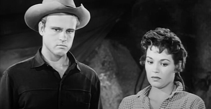 John Ericson as Jack Slade Jr. and Angie Dickson as Polly Logan, mourning the loss of a friend in The Return of Jack Slade (1958)