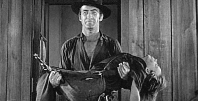 Mark Stevens carrying away the body of a young boy caught in a shoot-out in Jack Slade (1953)