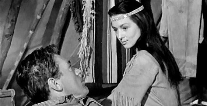 May Wynn as Ectay-O-Wahnee, nursing Bob Garth (William Bishop) back to health in The White Squaw (1956)