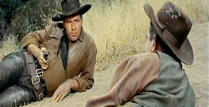 Philip Carey as Brady Sutton, wondering why Charlie Veer risked his life to save him from a possible lynching in Wyoming Renegades (1955)