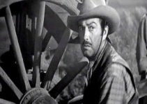 Robert Taylor as Buck Wyatt, hearing a desperate call for help in Westward the Women (1951)