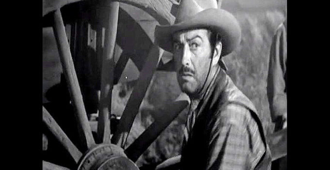 Robert Taylor as Buck Wyatt, hearing a desperate call for help in Westward the Women (1951)