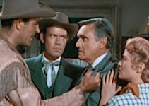 Rod Cameron as Tom Clay confronting Arthur Pickett (Morris Ankrum) about the lack of supplies reaching the Osage tribe while Travers (John Ridgely) and Ann (Jane Nigh) look on in Fort Osage (1952)