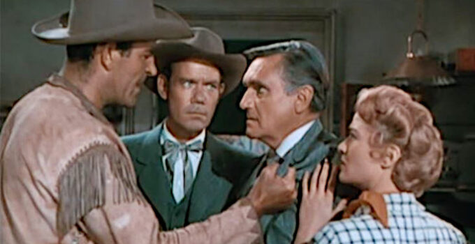 Rod Cameron as Tom Clay confronting Arthur Pickett (Morris Ankrum) about the lack of supplies reaching the Osage tribe while Travers (John Ridgely) and Ann (Jane Nigh) look on in Fort Osage (1952)