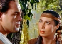 Scott Brady as Jonathan Adams, being warned of pending trouble by Onida (Rita Gam) in Mohawk (1956)