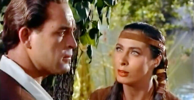 Scott Brady as Jonathan Adams, being warned of pending trouble by Onida (Rita Gam) in Mohawk (1956)