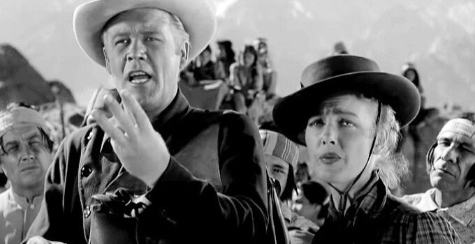 Wayne Morris as Ford Smith and Virginia Grey as Mary Smith, trying to explain the plight they're facing to an Indian leader in Desert Pursuit (1952)