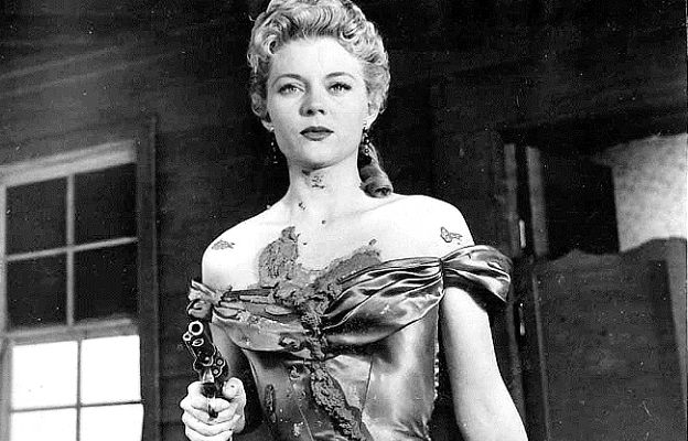 Peggie Castle as Marie 'Oklahoma' Saunders, mud splattered as residents turn against her in The Oklahoma Woman (1956)