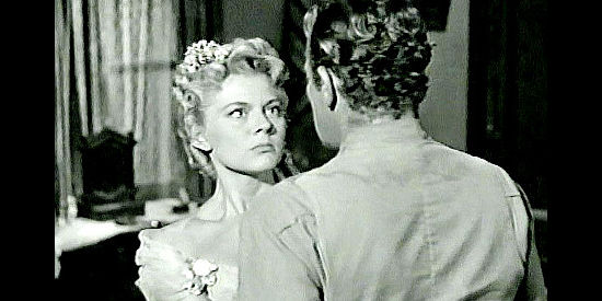 Peggy Castle as Kate Masters, ignoring Dan Corbin's warning about the danger she faces in Two-Gun Lady (1955)