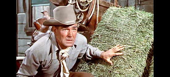 Randolph Scott as Bart Allison, taking cover in a stable as the hunter becomes the hunted in Decision at Sundown (1957)