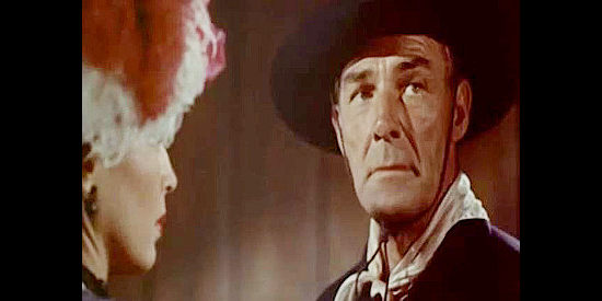 Randolph Scott as Jim Kipp, realizing Alice Williams was married to the man lying dead in an alley in The Bounty Man (1954)