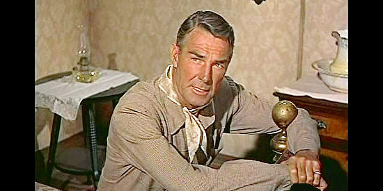 Randolph Scott as Larry Madden, returning after five years to avenge a wrong by Tuck Ordway in Tall Man Riding ((1955)