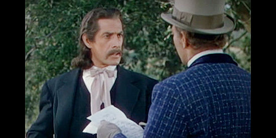 Reed Hadley as Wild Bill Hickok, helping ensure Reb Hollister is no longer a wanted man in Dallas (1950)