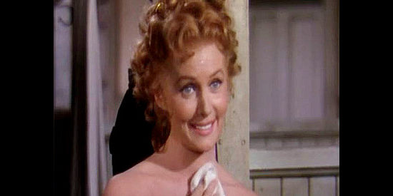 Rhonda Fleming as Evelyn Hastings, poking catty fun at Denny's short hair in Pony Express (1953)