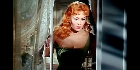Rhonda Fleming as The Duchess, checking out the trouble below her window in Tennessee's Partner (1955)