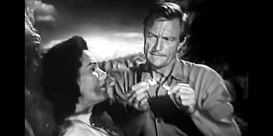 Richard Denning as Doc Merritt, preparing to take a bullet out of Angela (Patricia Medina) in The Buckskin Lady (1957)