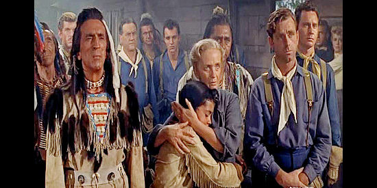 Richard Hale as Isaiah (left) and Olive Carey as Anne Avery among those listening to 1st Sgt. Emmett Bell after an attack has been repulsed in Pillars of the Sky (1956)