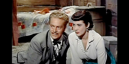 Richard Webb as Ace Elliott with his wife Paris (Roberta Haynes) as the station is attacked in The Nebraskan (1953)
