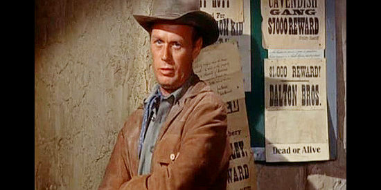 Richard Widmark as Jim Slater, a man looking for the killer of a father he never knew in Backlash (1956)