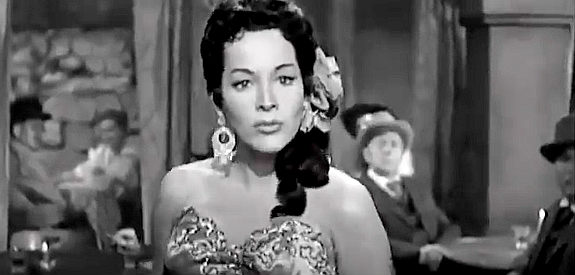 Rita Baron as Conchita, entertaining patrons of the town saloon with a song and her whip in The Broken Star (1956)