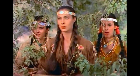 Rita Gam as Onida, spotting Jonathan Adams for the first time while her friends react ot him kissing Greta Jones in Mohawk (1956)