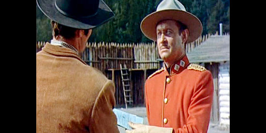 Robert Douglas as Maj. Benton, receiving arrest orders for Grace Markey from Marshal Carl Smith in Saskatchewan (1954)