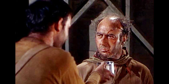 Robert Griffin as Kirby, one of Kruger's loyal men, being taunted by Tippy in Barricade (1950)