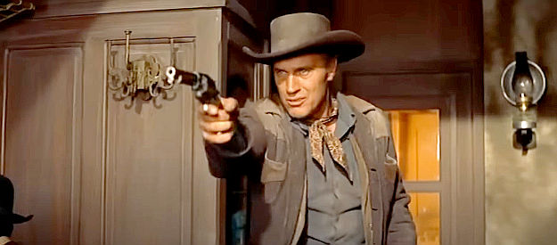 Robert J. Wilke as Concho, one of Whitey Harbin's gang members, helping in a train holdup in Night Passage (1957)