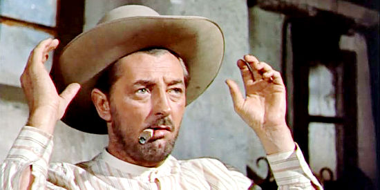 Robert Mitchum as Martin Brady, trying on an American cowboy hat, and deciding a sombrero fits him better in The Wonderful Country (1959)