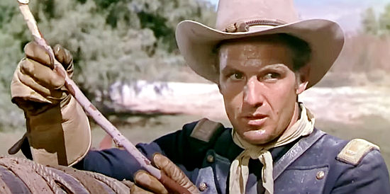Robert Stack as Lt. Billings, checking on the amount of water left for his men in War Paint (1953)