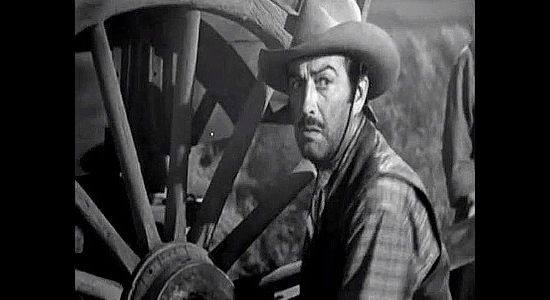 Robert Taylor as Buck Wyatt, reacting to the sound of a desperate call for help in Westward the Women (1951)