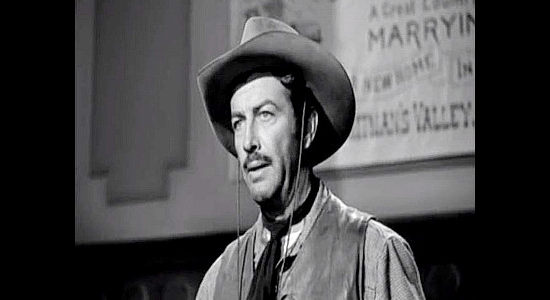 Robert Taylor as Buck Wyatt, warning the 150 women of the dangers they're about to face in Westward the Women (1951)