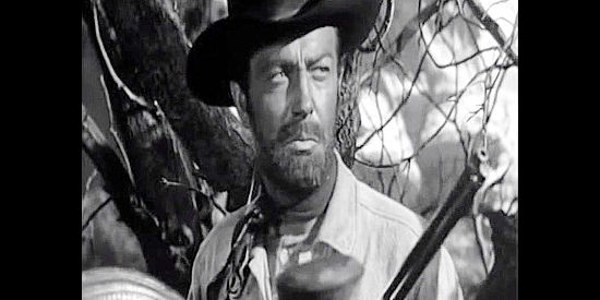 Robert Taylor as Ward Kinsman, on the lookout for Apaches in Ambush (1950)