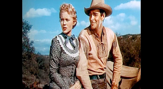 Rod Cameron as Jeff Curtis, expecting a kiss from Ann Wilkins in return for a safe ride down a hillside in Wagons West (1952)