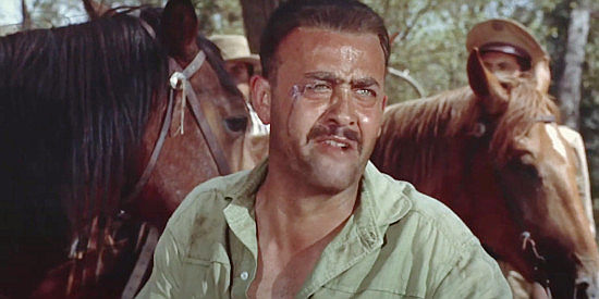 Rodolfo Hoyos Jr. as Cristino, the man who does Hermany's dirty deeds, pleading ignorance in The Americano (1955)